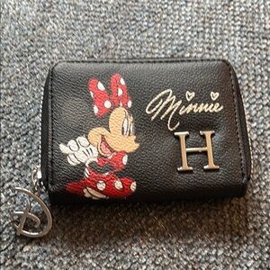 Disneys Minnie Mouse small wallet that has zipper all around the Letter H on it.